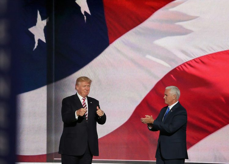 Donald Trump beside man in black suit