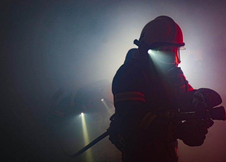 man in black helmet holding black stick