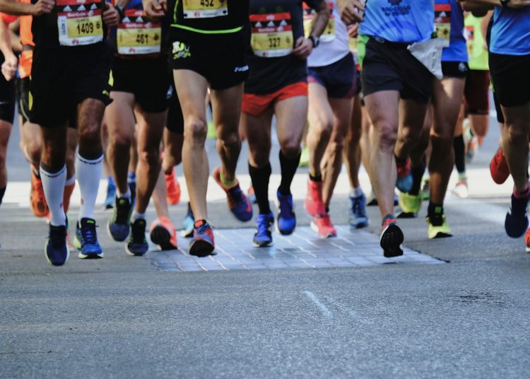 people running on gray asphalt road during daytime
